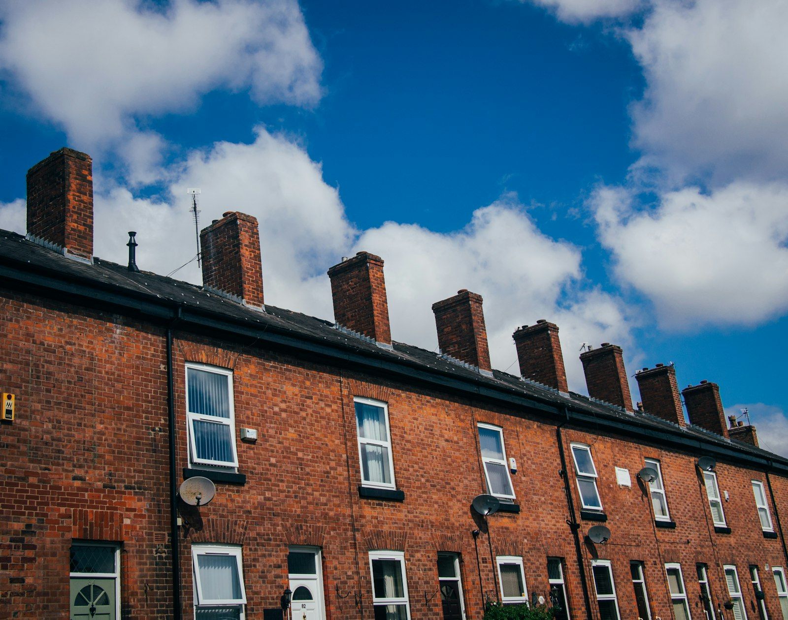 Rows of red-brick terraced houses and chimneys, typical of Wigan